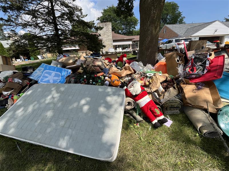 Massive piles of damaged items are forming outside of homes along the Menomonee River Parkway in Wauwatosa as the community begins to recover from the devastating floods.