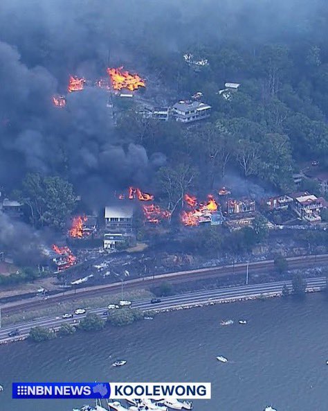 At least six homes destroyed as wildfire in Koolewong town of New South Wales, Australia, disrupts train services, triggers evacuations, officials say.